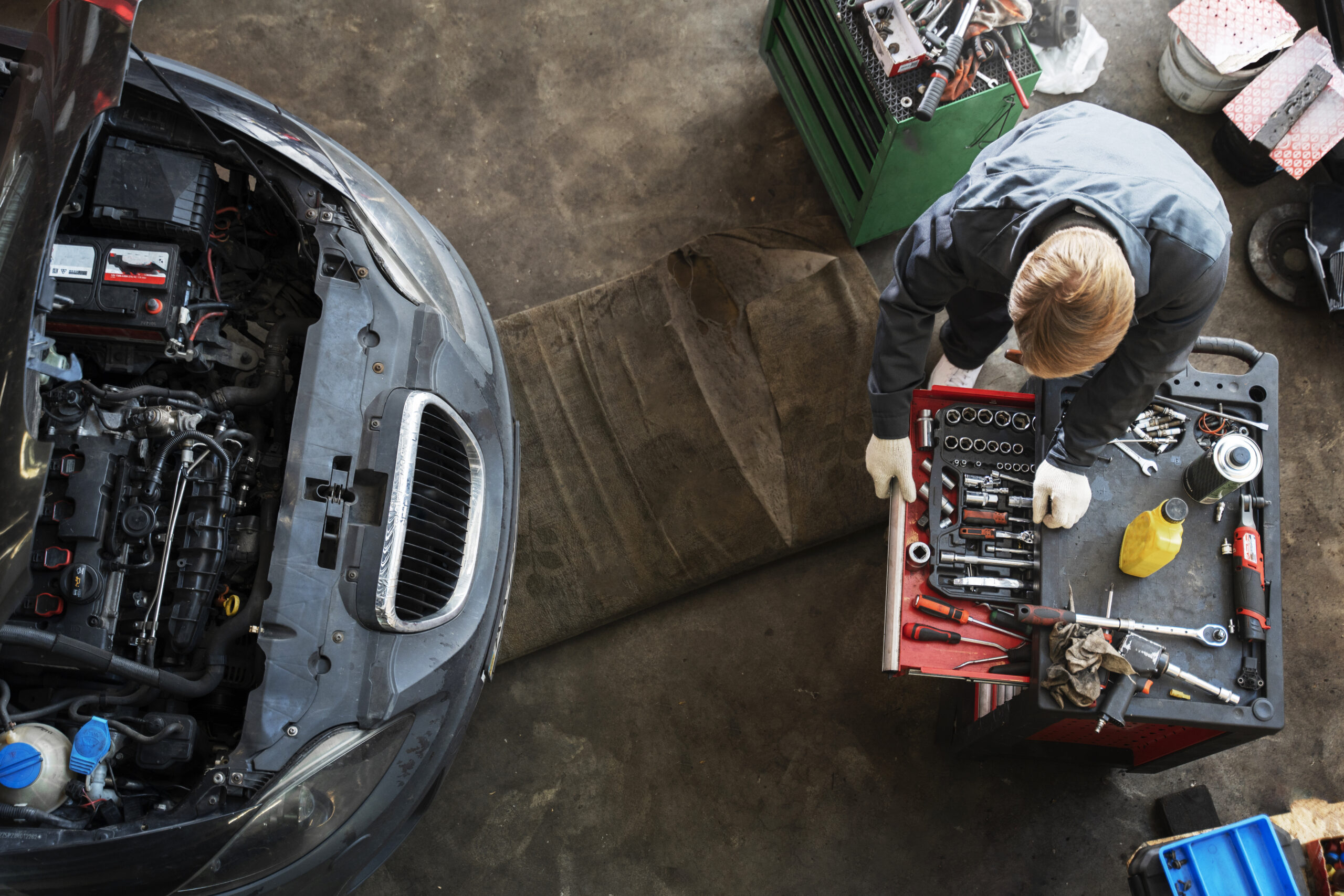 top view man repairing car